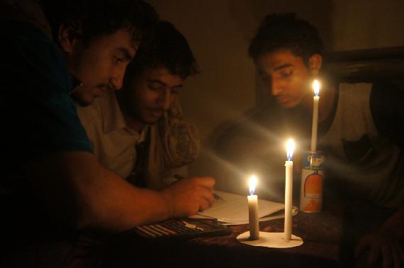 Yemeni students study for final exams, under candlelight, in Sanaa 